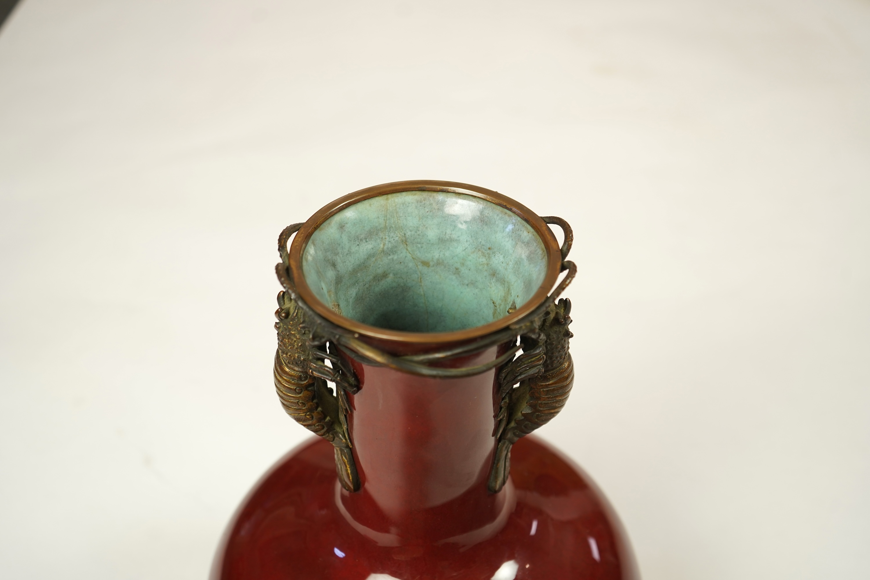 An unusual Japanese sang-de-boeuf ground cloisonné enamel and gilt metal mounted vase